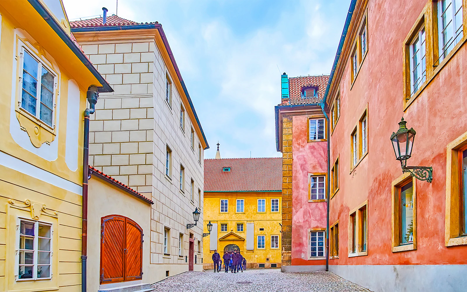 Colourful houses on Golden Lane in Prague with cobblestone street.