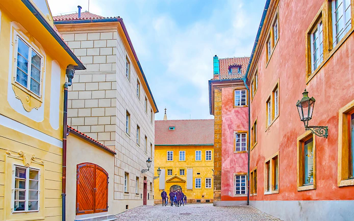 Colourful houses on Golden Lane in Prague with cobblestone street.