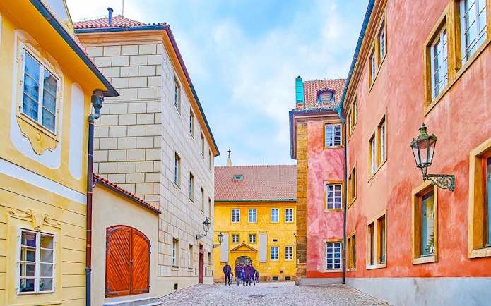 Colourful houses on Golden Lane in Prague with cobblestone street.