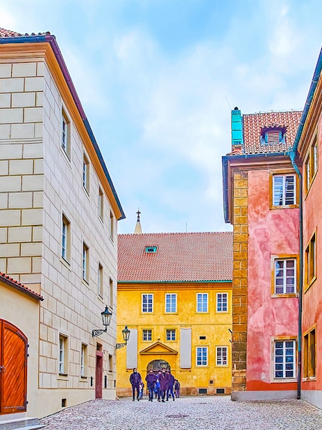 Colourful houses on Golden Lane in Prague with cobblestone street.