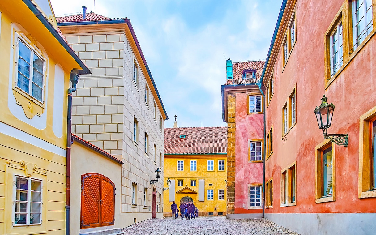 Colourful houses on Golden Lane in Prague with cobblestone street.