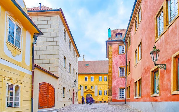 Colourful houses on Golden Lane in Prague with cobblestone street.