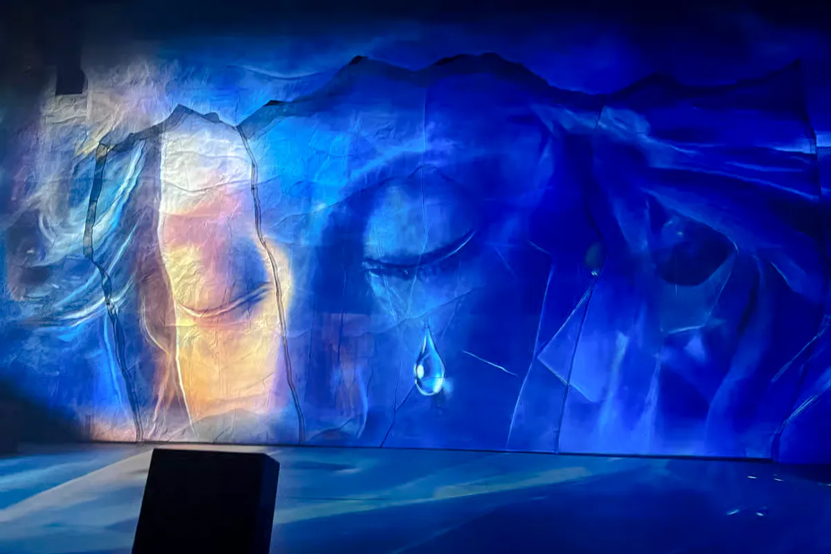 Backdrop of Chongqing International Circus City with abstract blue and orange design for Yangtze River Acrobatic Show.