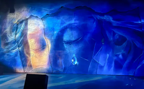 Backdrop of Chongqing International Circus City with abstract blue and orange design for Yangtze River Acrobatic Show.