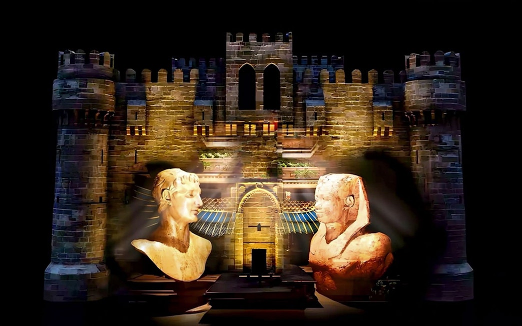 Qaitbay Citadel illuminated with ancient statues in Alexandria, Egypt.