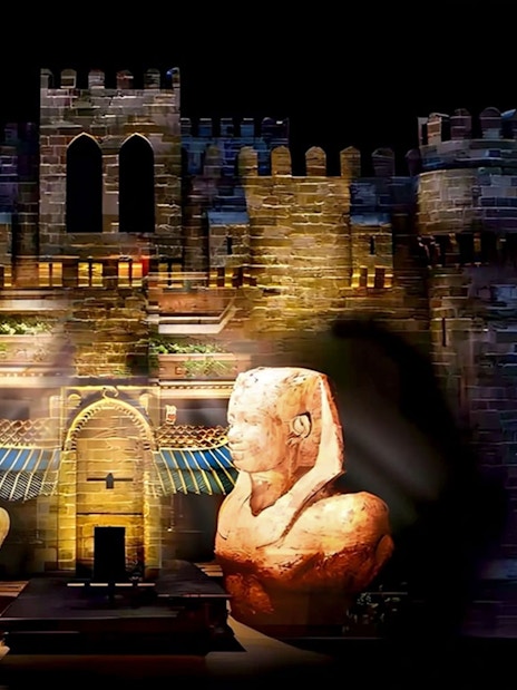 Qaitbay Citadel illuminated with ancient statues in Alexandria, Egypt.