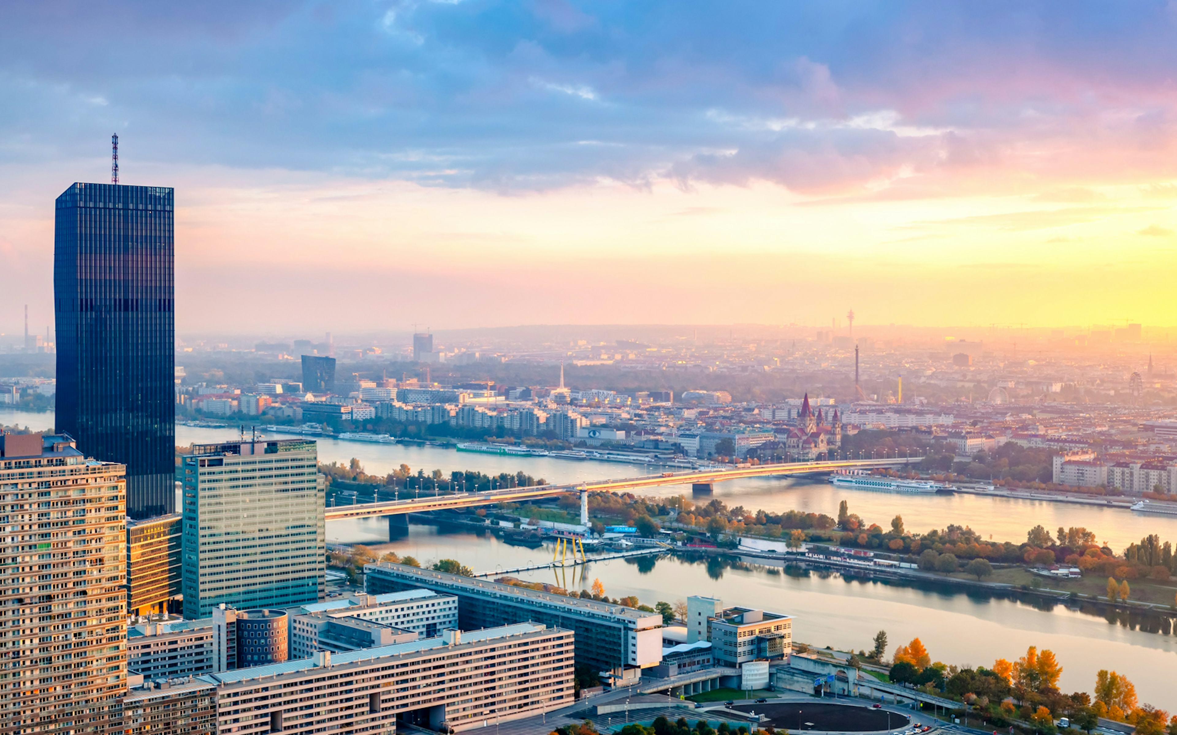Sunset view over Vienna with Danube River and city skyline.