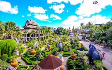 Nong Nooch Tropical Garden with lush greenery, sculptures, and traditional Thai architecture.