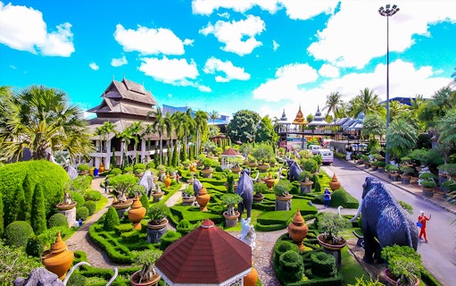 Nong Nooch Tropical Garden with lush greenery, sculptures, and traditional Thai architecture.