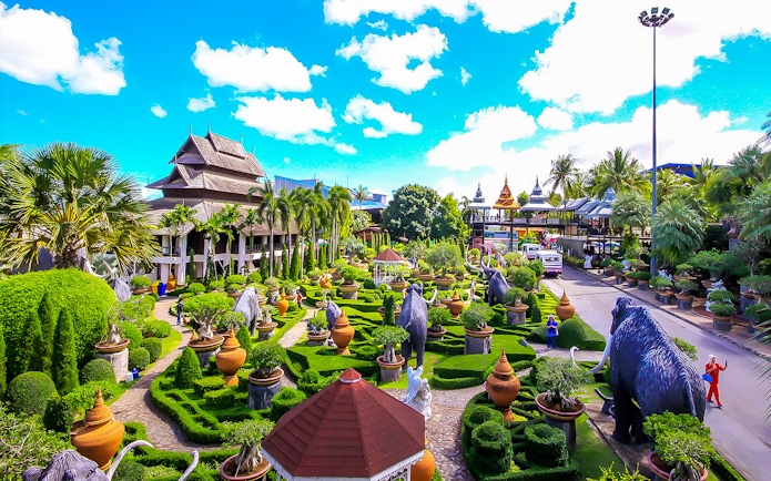 Nong Nooch Tropical Garden with lush greenery, sculptures, and traditional Thai architecture.