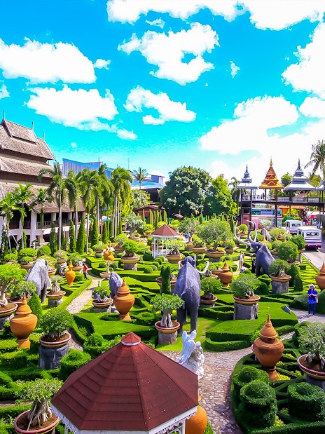 Nong Nooch Tropical Garden with lush greenery, sculptures, and traditional Thai architecture.