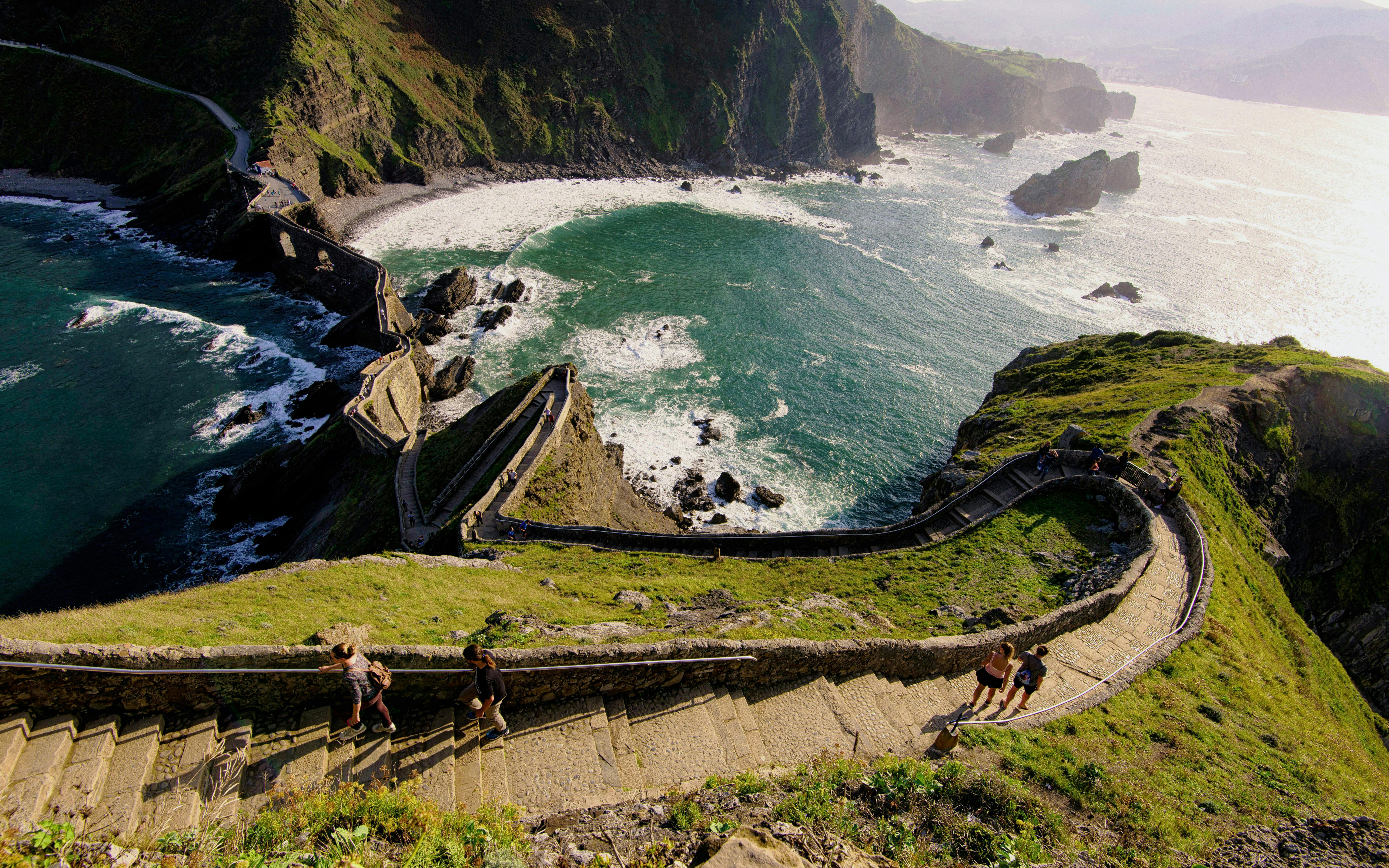 Steep stone steps leading to San Juan de Gaztelugatxe with ocean views in Basque Country, Spain.