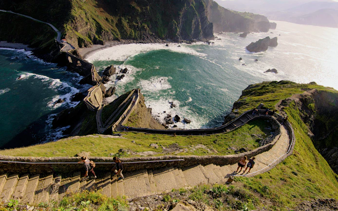Steep stone steps leading to San Juan de Gaztelugatxe with ocean views in Basque Country, Spain.