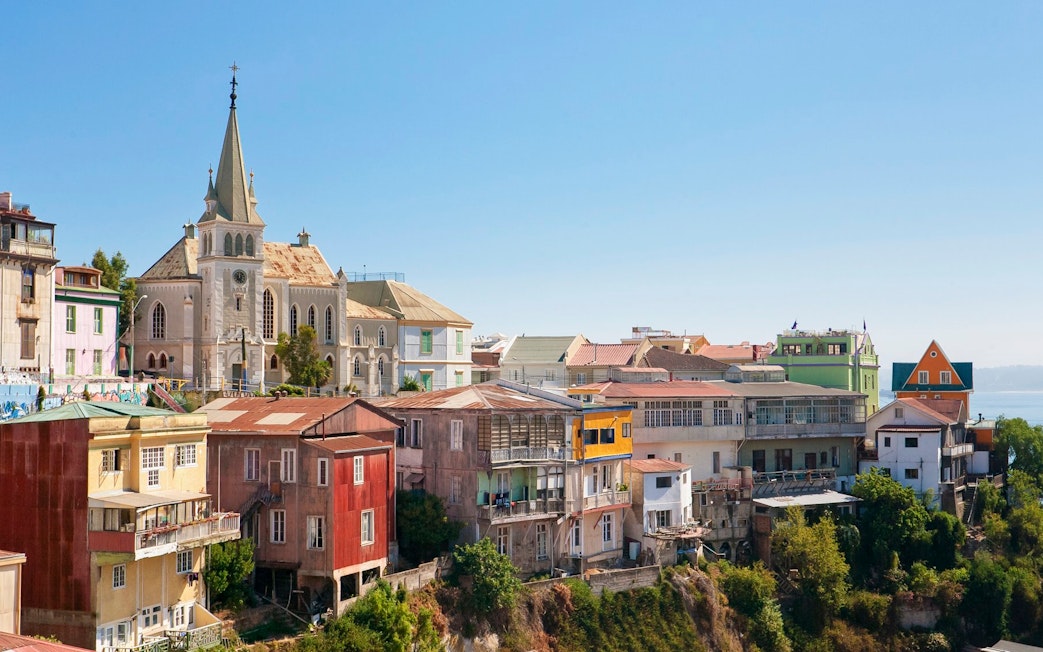 Colorful hillside buildings and a church in Valparaíso, Chile.