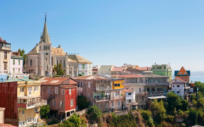 Colorful hillside buildings and a church in Valparaíso, Chile.