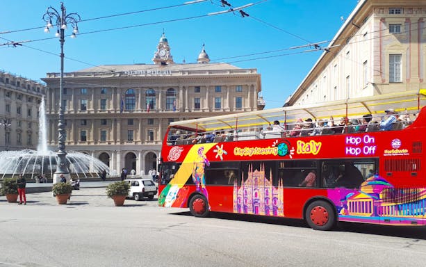 Open-top sightseeing bus in front of Piazza De Ferrari, Genoa, Italy.
