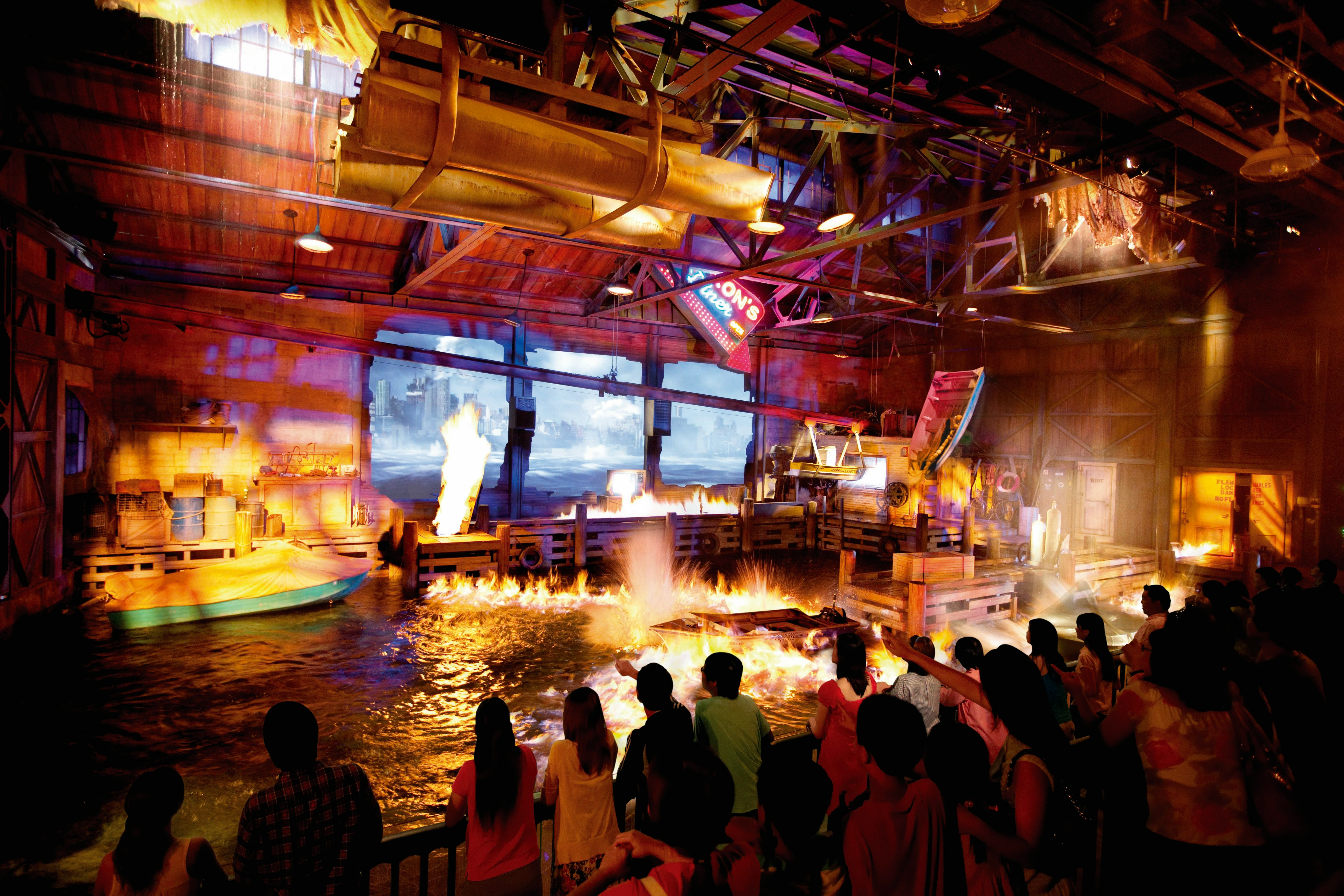 Audience watching fire and water effects at Lights, Camera, Action show, Universal Studios Singapore.