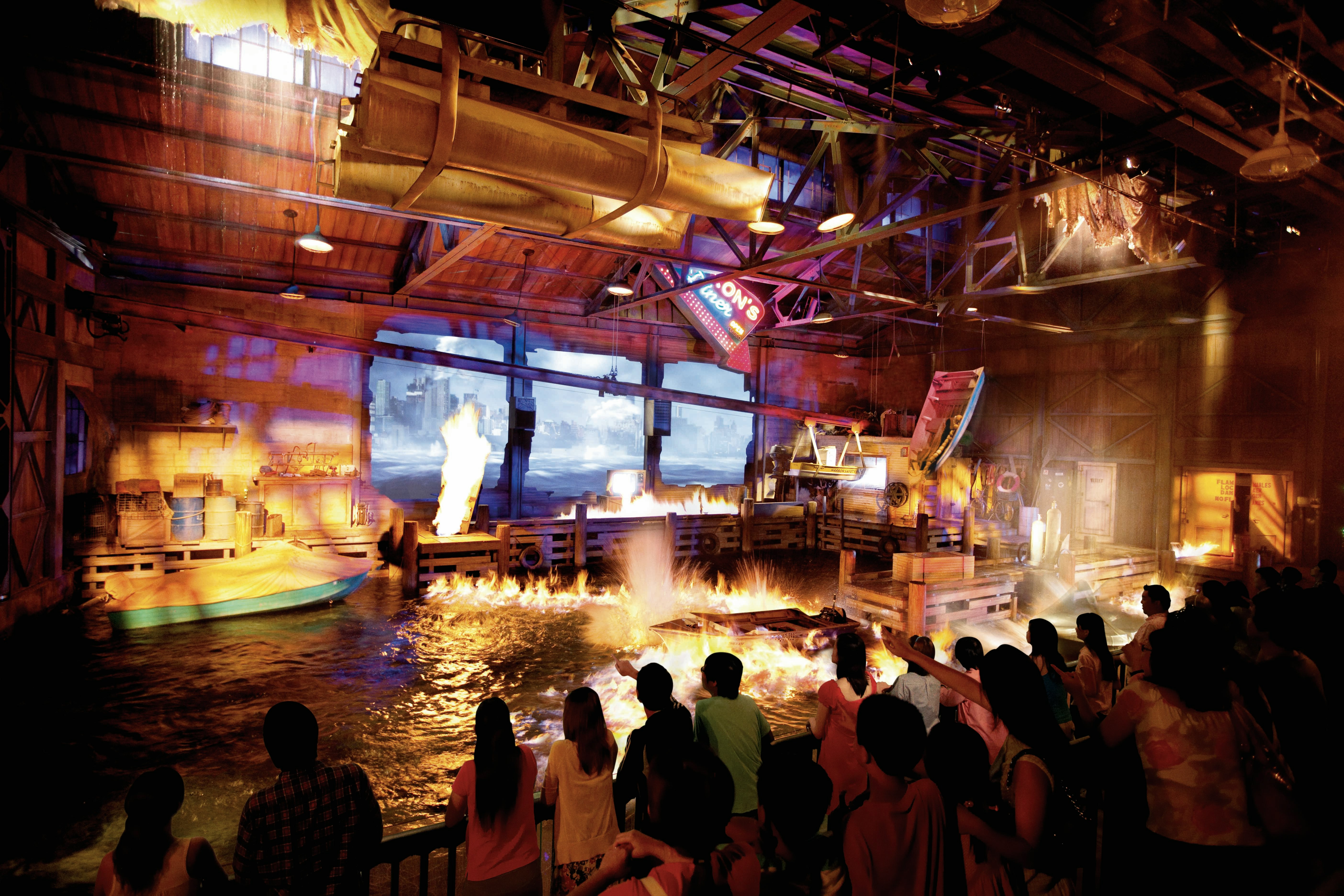 Audience watching fire and water effects at Lights, Camera, Action show, Universal Studios Singapore.