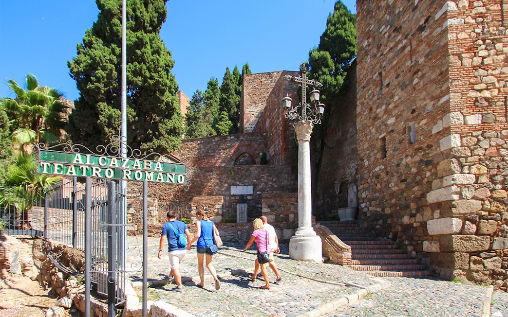 Visitors walking towards Alcazaba Castle entrance, Málaga, on Roman Theater tour.