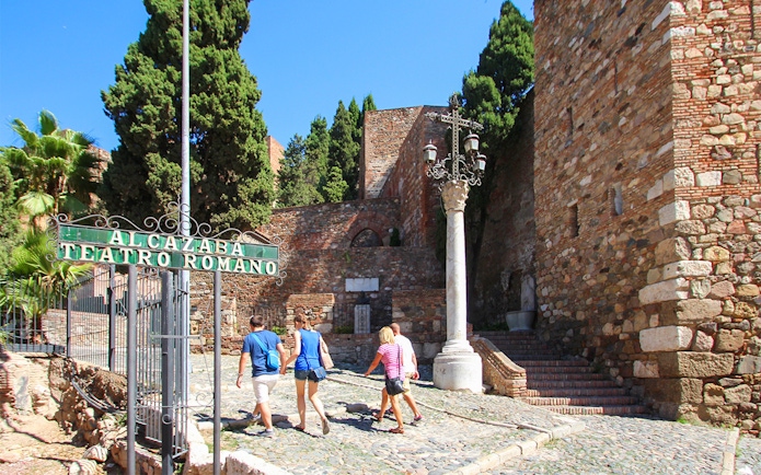 Visitors walking towards Alcazaba Castle entrance, Málaga, on Roman Theater tour.