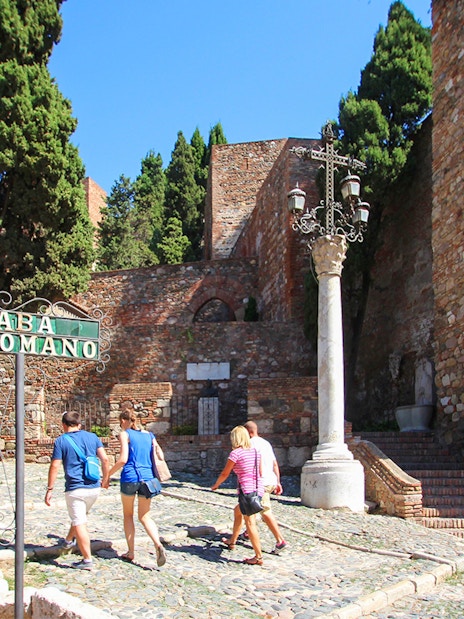 Visitors walking towards Alcazaba Castle entrance, Málaga, on Roman Theater tour.