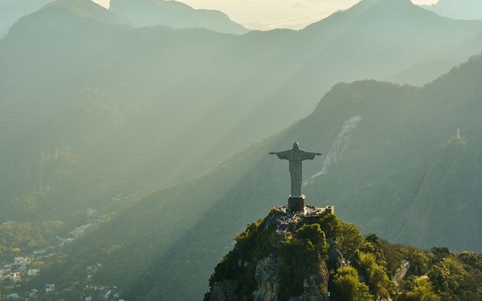 Aerial view of Christ the Redeemer statue in Rio de Janeiro during morning light.