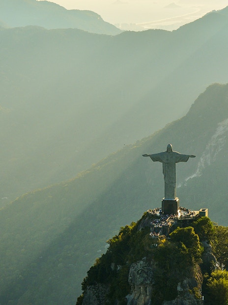 Aerial view of Christ the Redeemer statue in Rio de Janeiro during morning light.