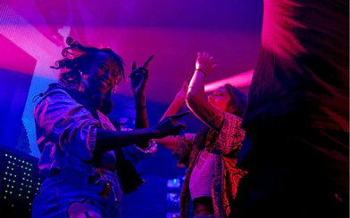 Guests enjoying a vibrant dance floor inside a lively club.