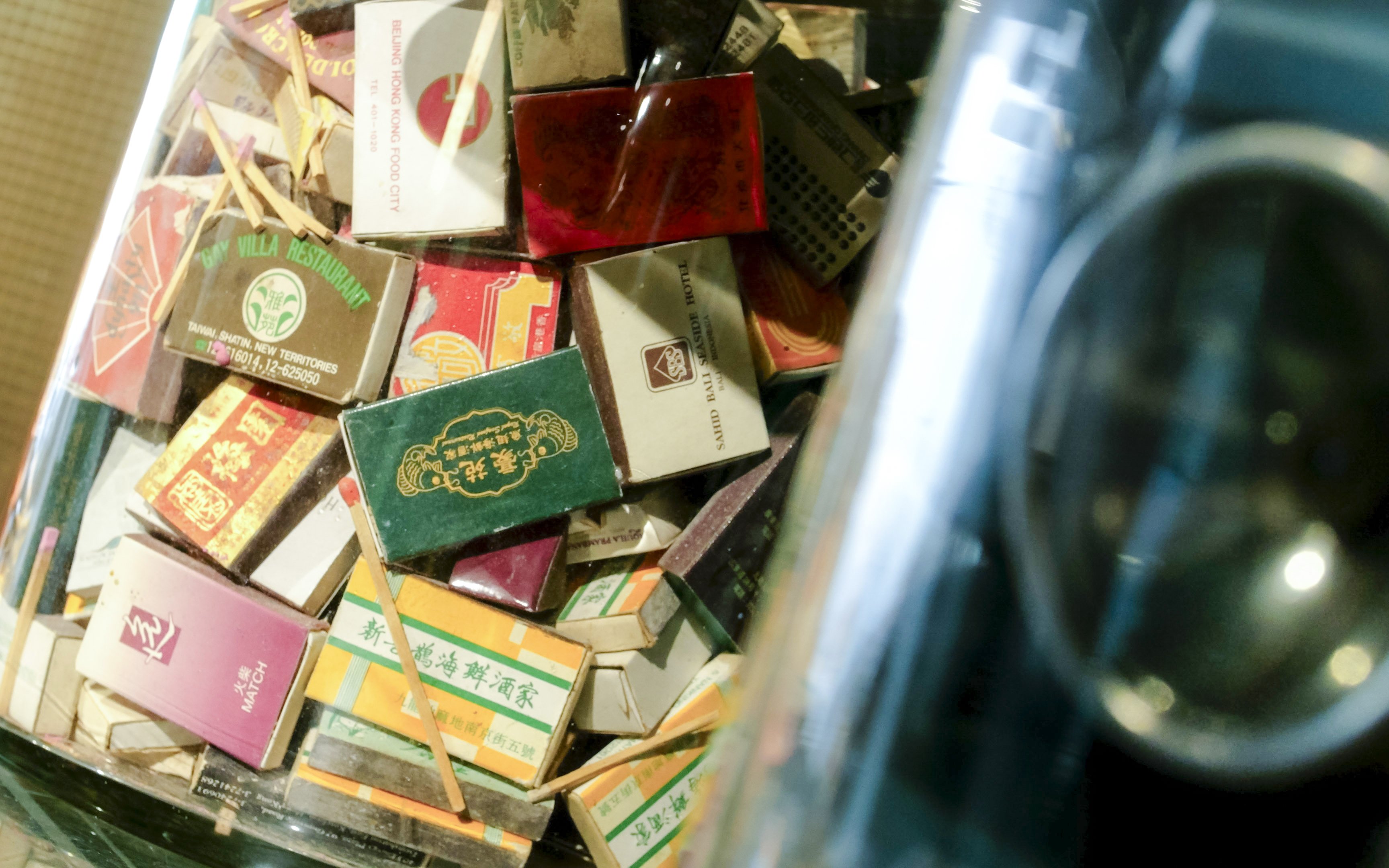 Collection of vintage matchboxes from Hong Kong restaurants, related to Peak Tram & Sky Terrace tour.