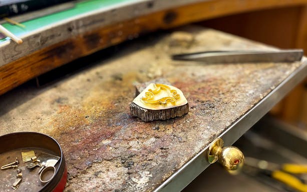Sardinian jewelry piece on a workbench during a workshop in Oristano.