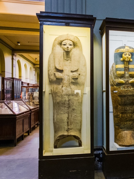 Ancient Egyptian sarcophagi displayed in a museum exhibit.