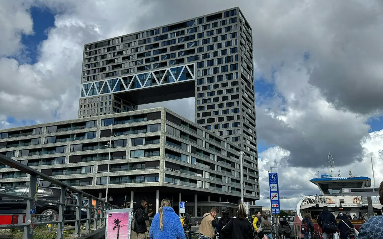Modern building near ferry terminal in Amsterdam, part of the Ship-Sinking Secret city exploration game.