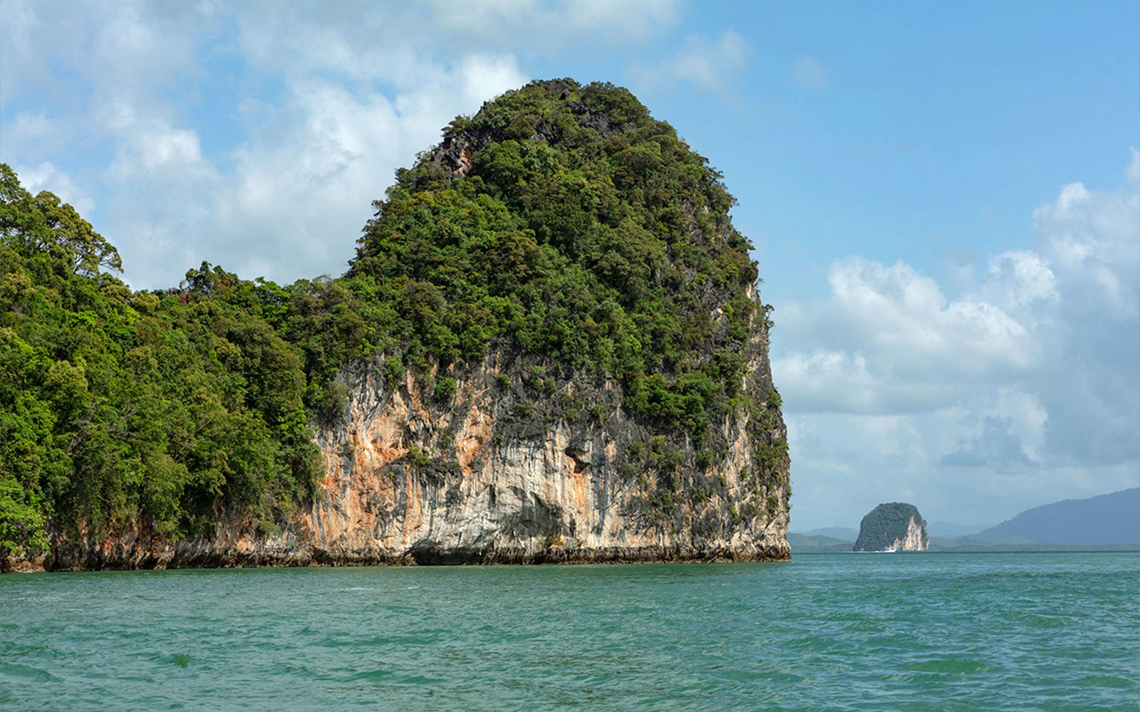 Phang Nga Bay limestone cliffs and green waters on a private charter from Phuket.