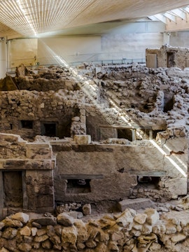 Akrotiri ruins with ancient stone structures, Santorini, Greece.