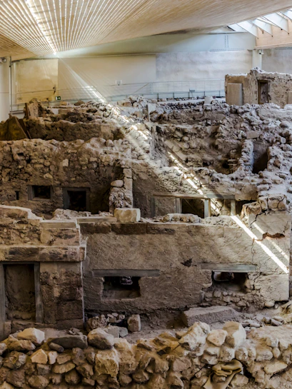 Akrotiri ruins with ancient stone structures, Santorini, Greece.