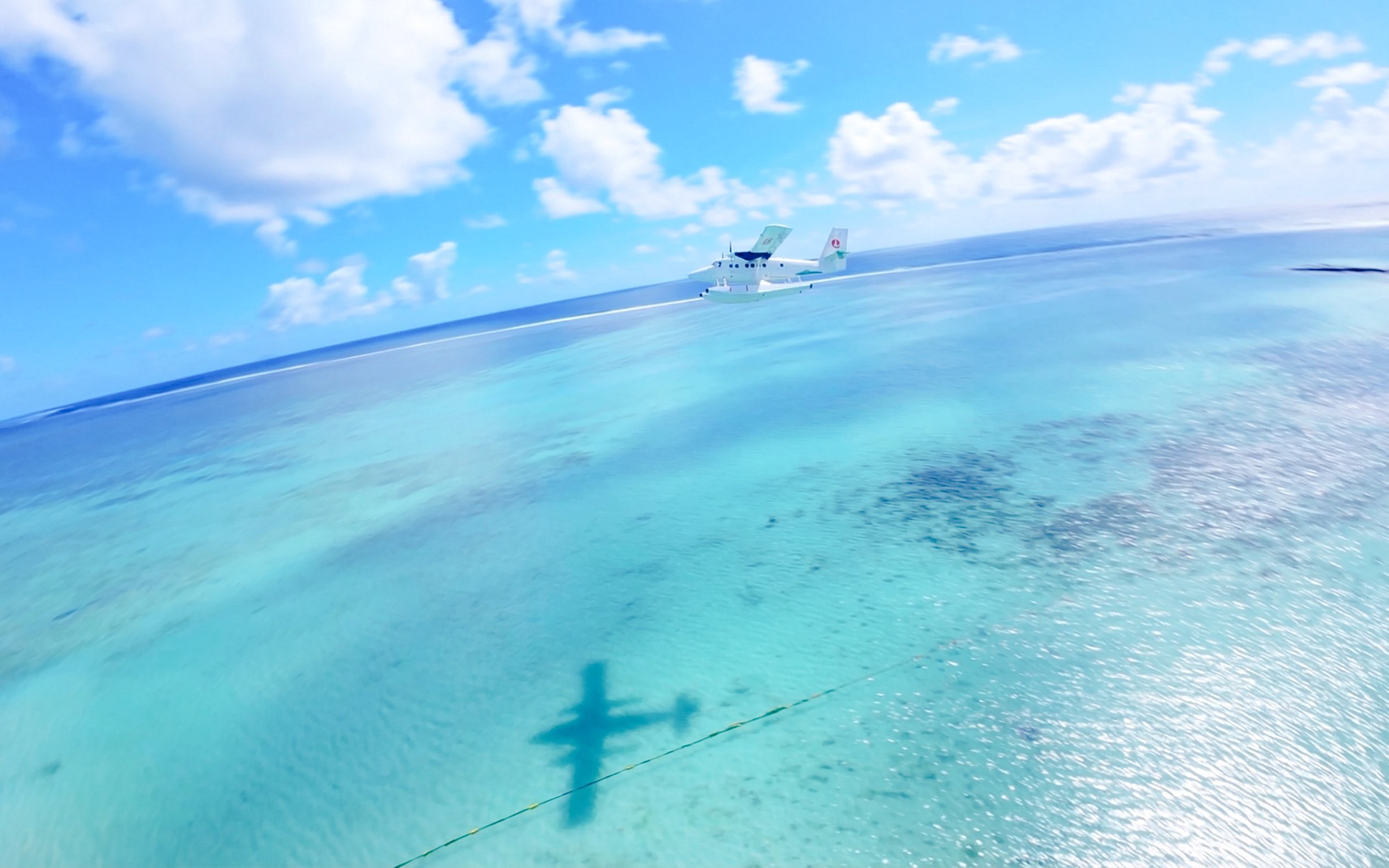 Seaplane flying over turquoise waters on Eastern Underwater Waterfall route, Mauritius.