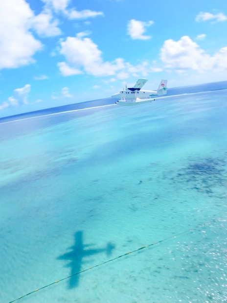 Seaplane flying over turquoise waters on Eastern Underwater Waterfall route, Mauritius.
