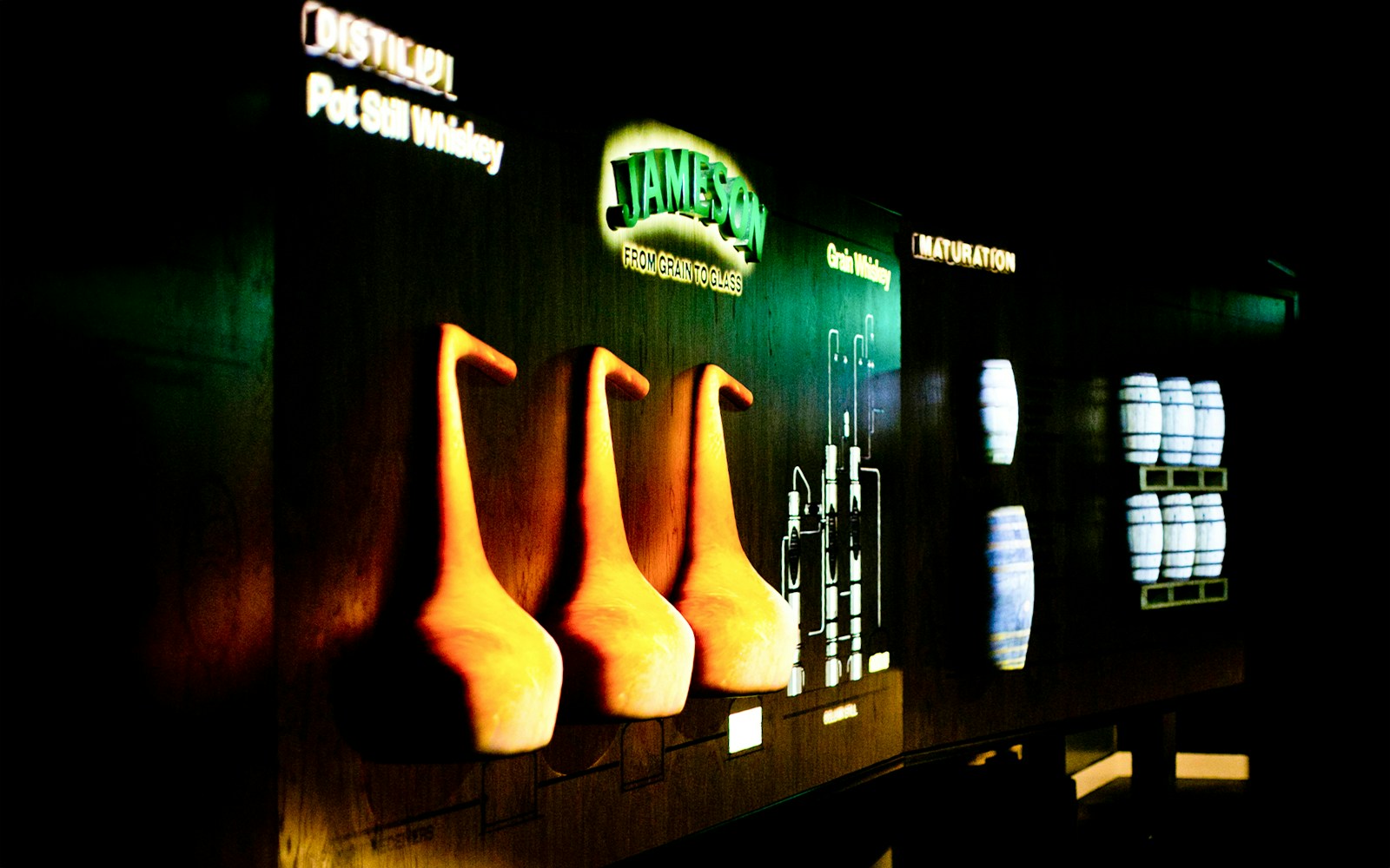 Jameson Distillery display with pot stills and whiskey barrels.