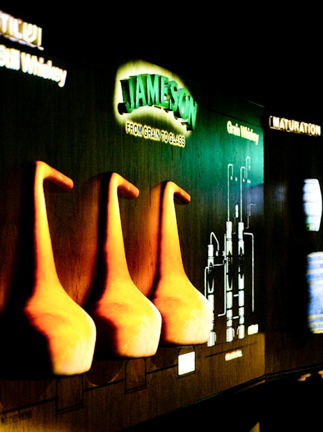 Jameson Distillery display with pot stills and whiskey barrels.