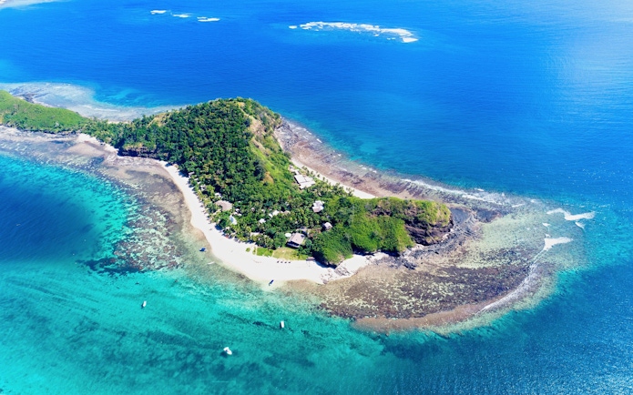 Aerial view of Mantaray Island Resort surrounded by turquoise waters, Fiji.