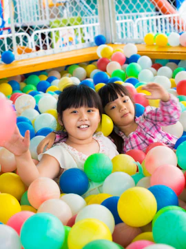 Children playing in a colorful ball pit at Kid's City, Macau.
