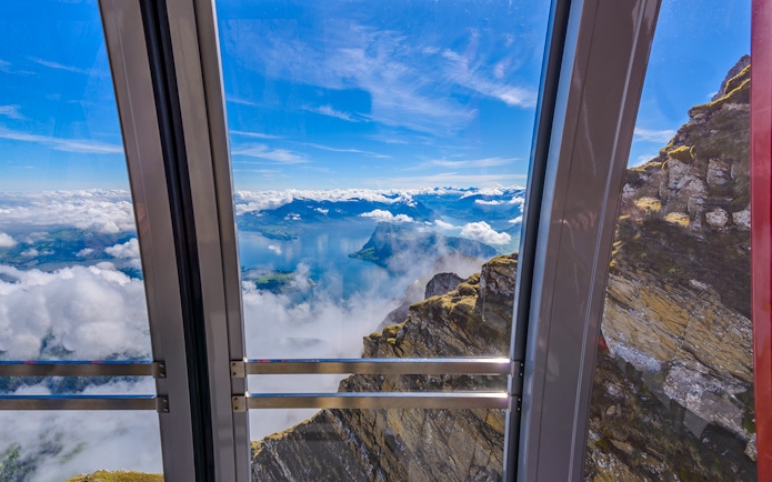 View from cable car to Pilatus Kulm, overlooking Lake Lucerne and surrounding mountains.