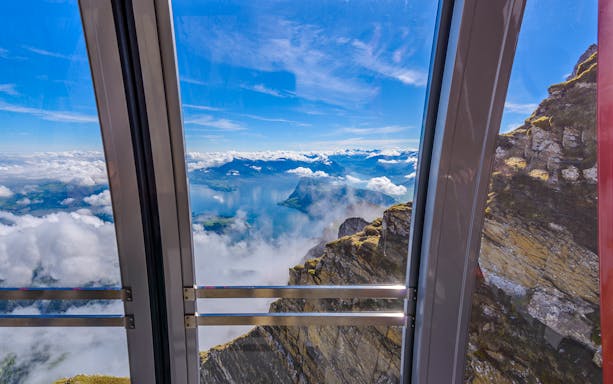 View from cable car to Pilatus Kulm, overlooking Lake Lucerne and surrounding mountains.