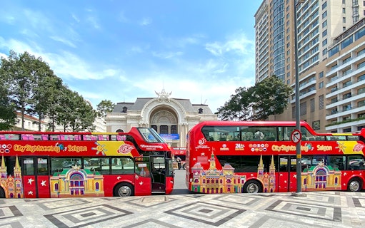 Ho Chi Minh City sightseeing bus in front of the Saigon Opera House.