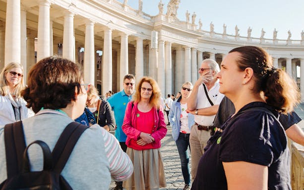 Tour guide leading tourists inside St. Peter’s Basilica, Vatican City.
