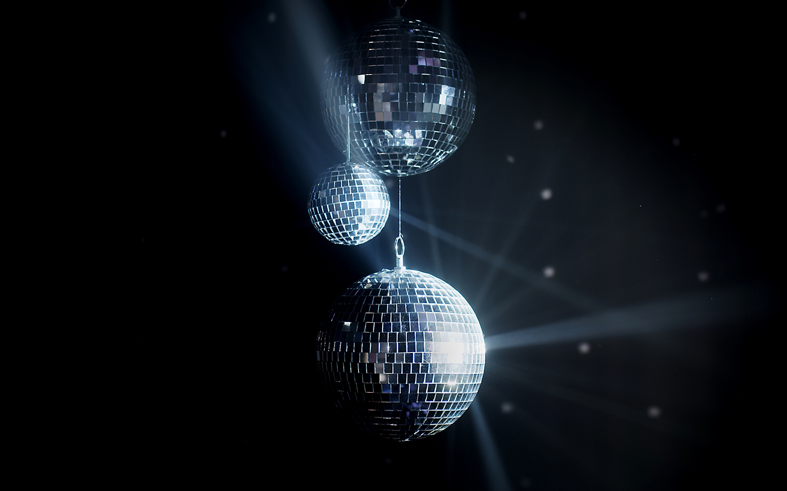 Silver disco ball illuminating at night