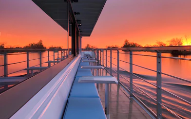 Berlin evening cruise deck with sunset reflecting on the water.