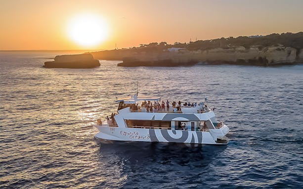 Catamaran on Albufeira sunset cruise with passengers enjoying a barbeque dinner.