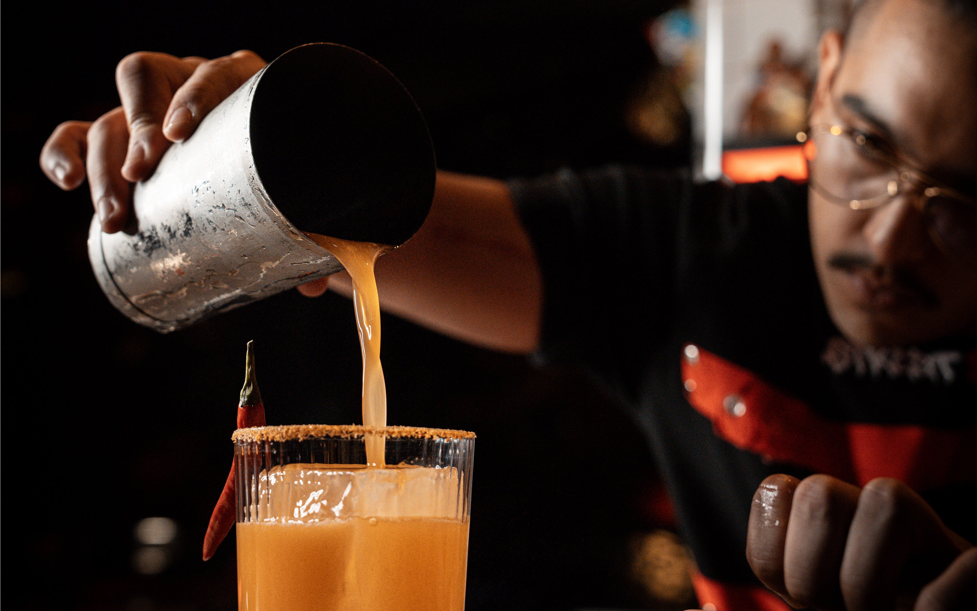 Bartender pouring cocktail at STREETXOLAND Saturday Brunch, Dubai.