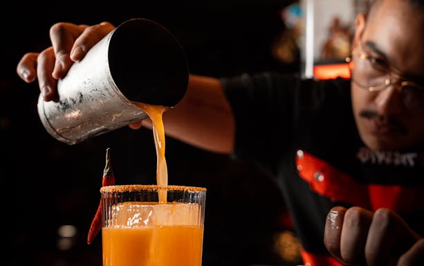 Bartender pouring cocktail at STREETXOLAND Saturday Brunch, Dubai.